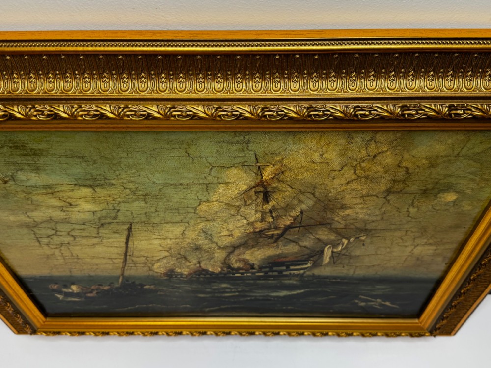 A framed 19th-century style maritime oil painting on canvas depicting a ship engulfed in flames on choppy seas, set within an ornate gilded frame. View VII