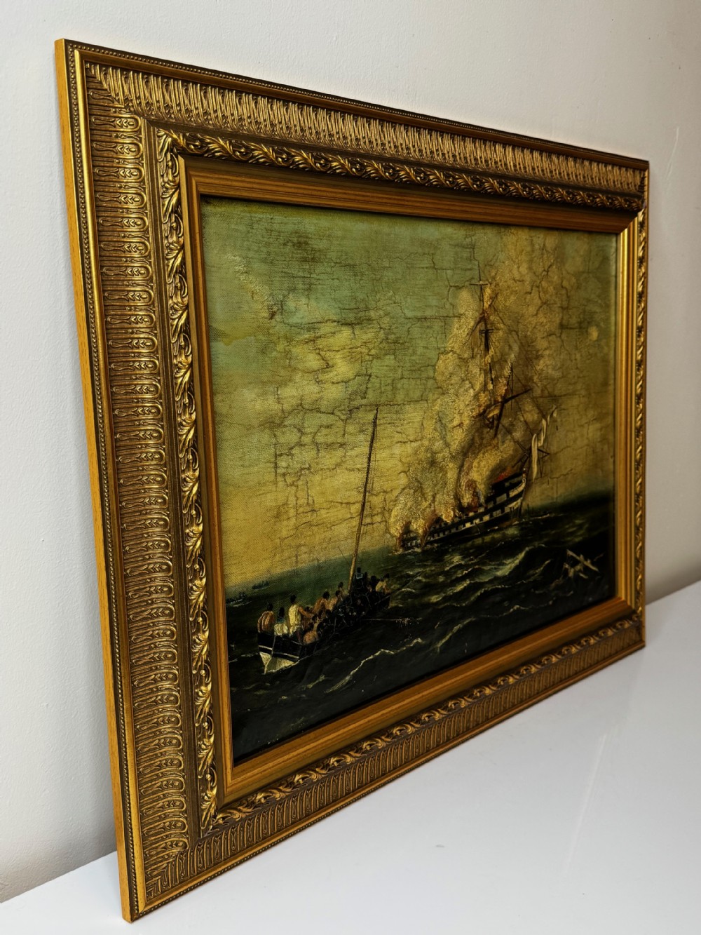 A framed 19th-century style maritime oil painting on canvas depicting a ship engulfed in flames on choppy seas, set within an ornate gilded frame. View VIII