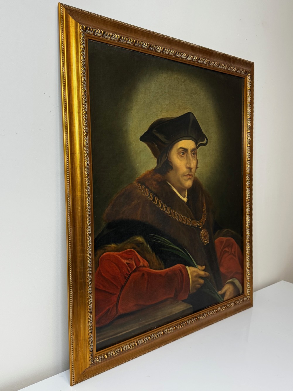 An oil portrait painting depicting Sir Thomas More framed in an ornate gold gilt wood frame. View III
