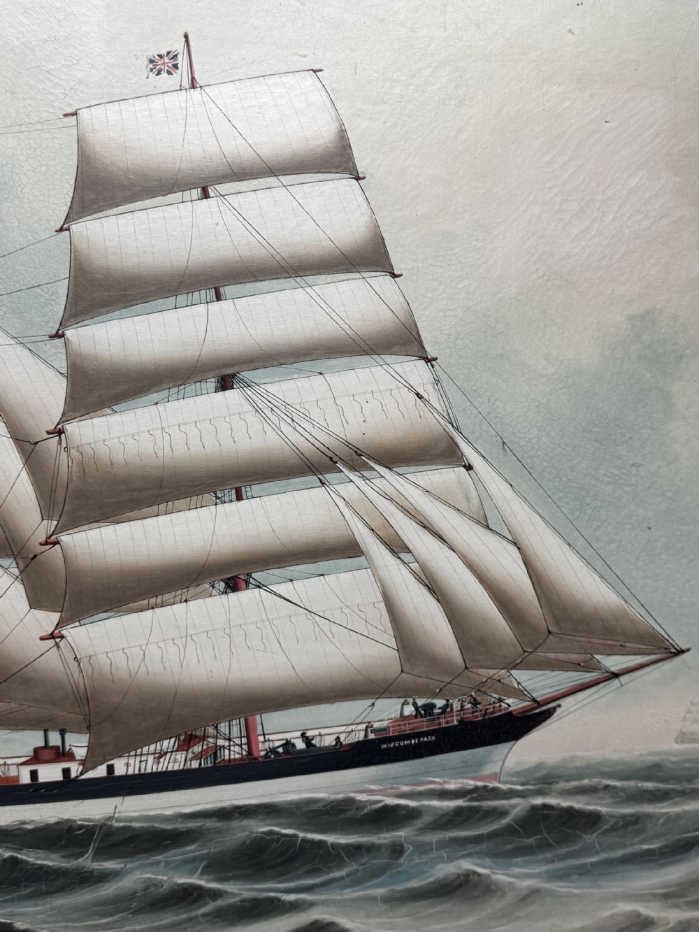 An antique oil painting depicting a three-masted sailing ship with white sails unfurled on ocean waves, enclosed within a moulded gold frame. View V