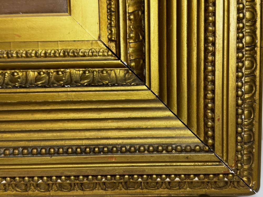 A Victorian oil painting depicting a lake landscape at sunset framed in a heavily moulded gilded frame. View XI