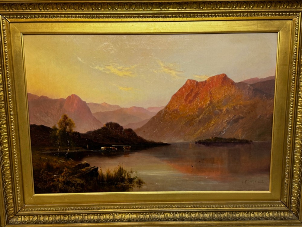 A Victorian oil painting depicting a lake landscape at sunset framed in a heavily moulded gilded frame. View XV