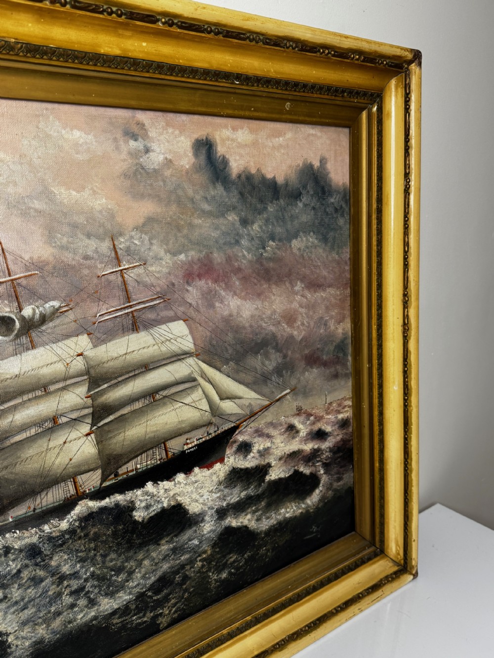 An oil painting depicting a five-masted vessel named Potosi sailing through turbulent ocean waves under a grey sky, enclosed in a gilded frame. View II