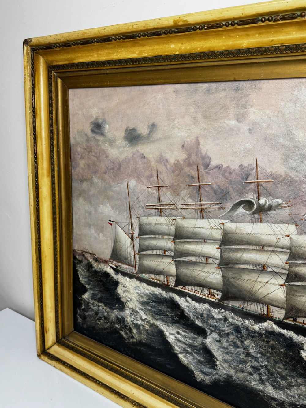 An oil painting depicting a five-masted vessel named Potosi sailing through turbulent ocean waves under a grey sky, enclosed in a gilded frame. View III