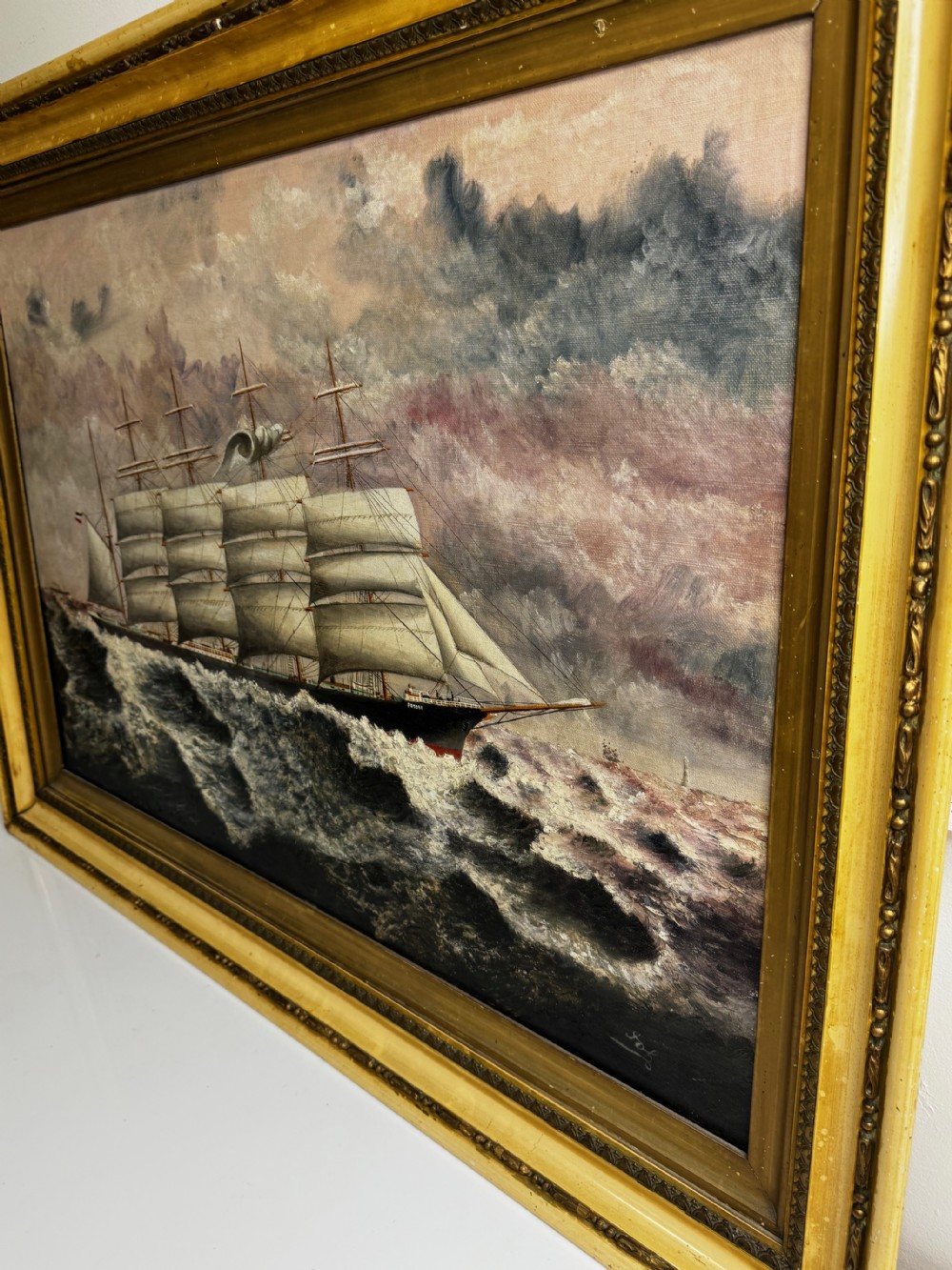 An oil painting depicting a five-masted vessel named Potosi sailing through turbulent ocean waves under a grey sky, enclosed in a gilded frame. View IX