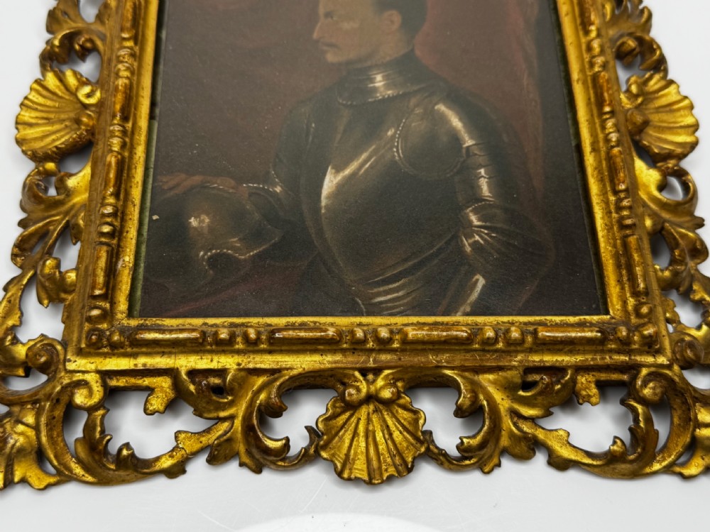An oil painting depicting a profiled male figure in steel armour set within a carved giltwood frame featuring shell and scroll motifs. View XV