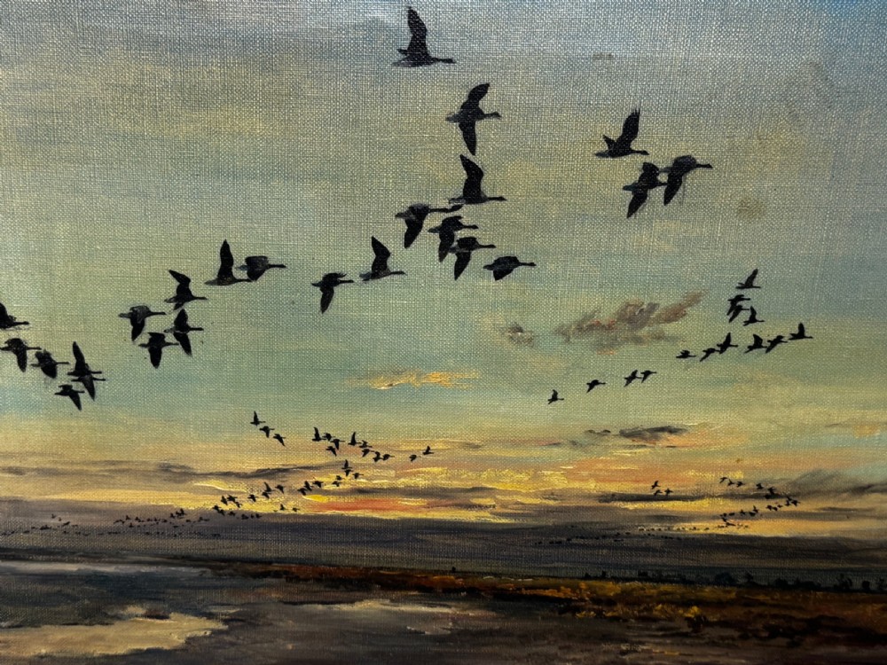 Framed oil painting depicting a skein of geese in flight over coastal marshlands at dusk. View XIV