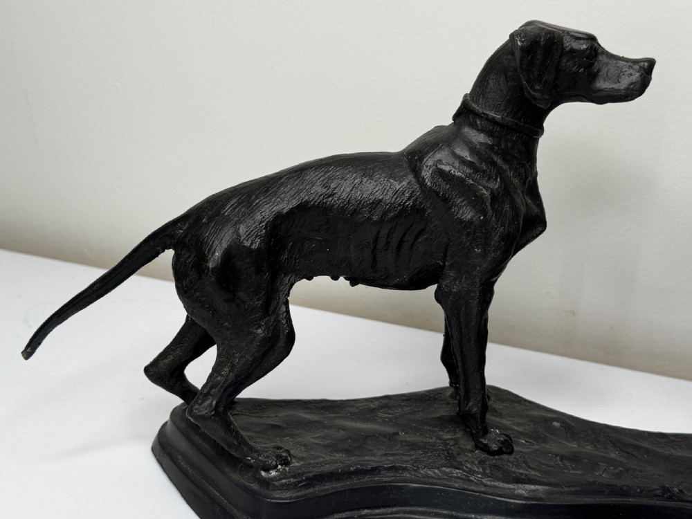 A dark patinated bronze sculpture depicting two hunting hound dogs in active poses on an integral naturalistic base. View IV