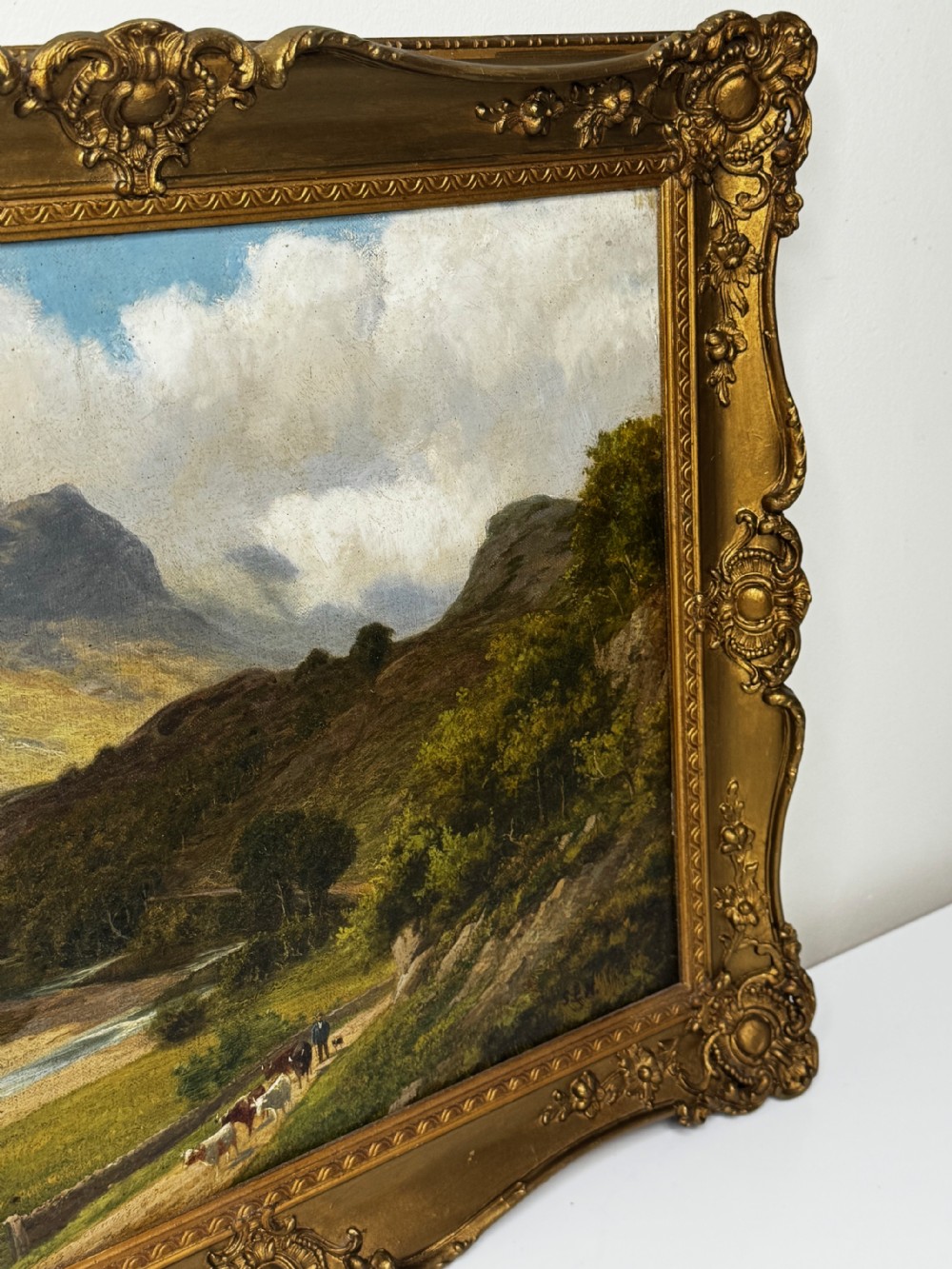 A Victorian landscape oil painting depicting the mountainous Borrowdale valley in the Lake District set within an ornate carved gold gilt frame. View II