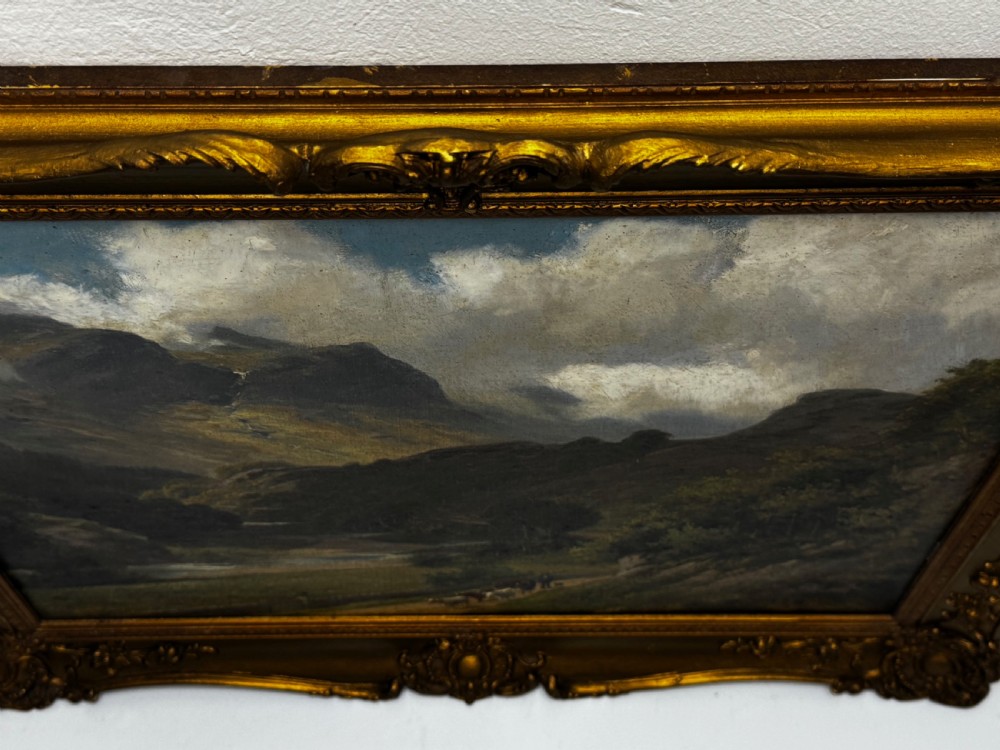 A Victorian landscape oil painting depicting the mountainous Borrowdale valley in the Lake District set within an ornate carved gold gilt frame. View VI