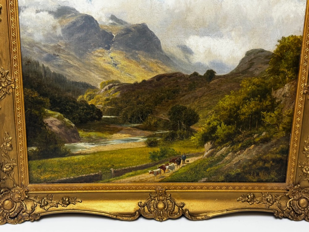 A Victorian landscape oil painting depicting the mountainous Borrowdale valley in the Lake District set within an ornate carved gold gilt frame. View X