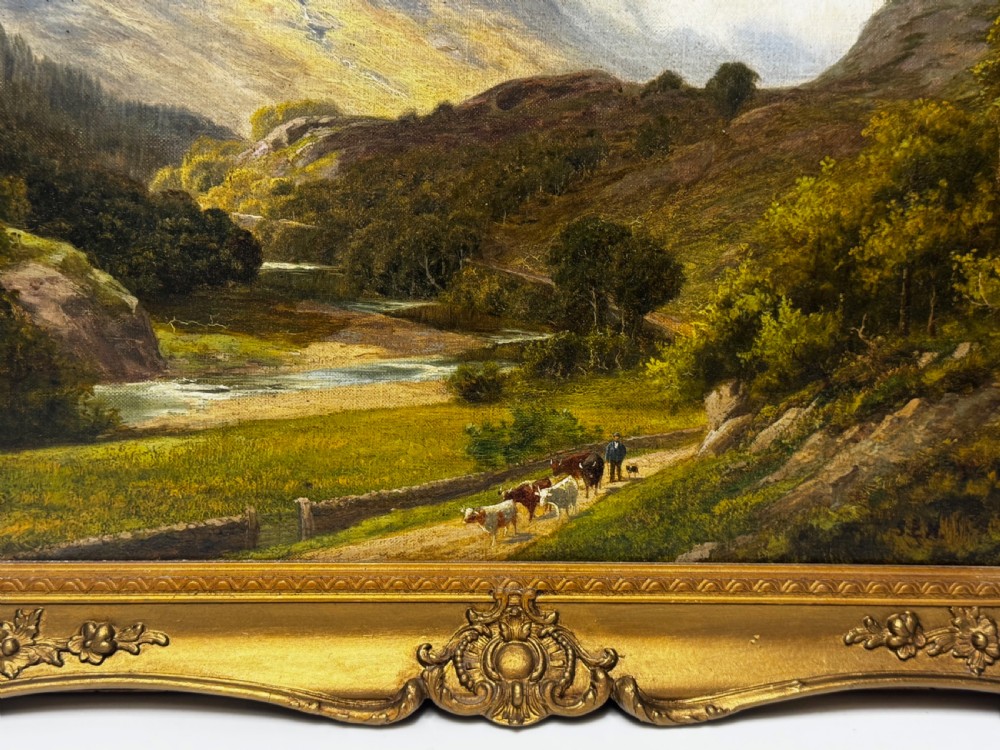 A Victorian landscape oil painting depicting the mountainous Borrowdale valley in the Lake District set within an ornate carved gold gilt frame. View XI