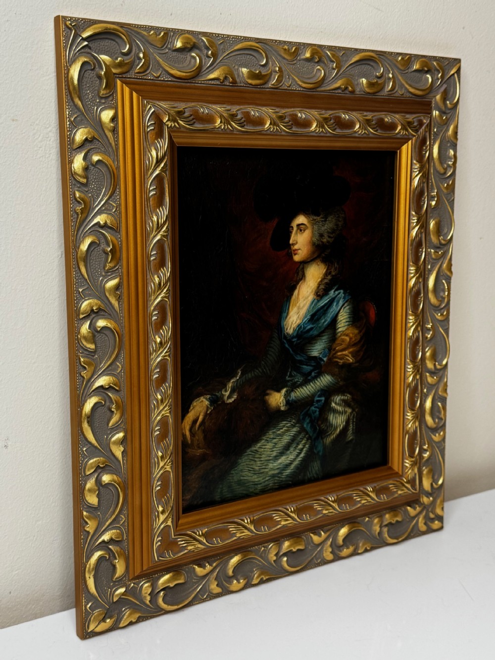 A framed 19th-century oil painting depicting Sarah Siddons in a blue gown and feathered hat, framed in ornate gilded moulding. View VI