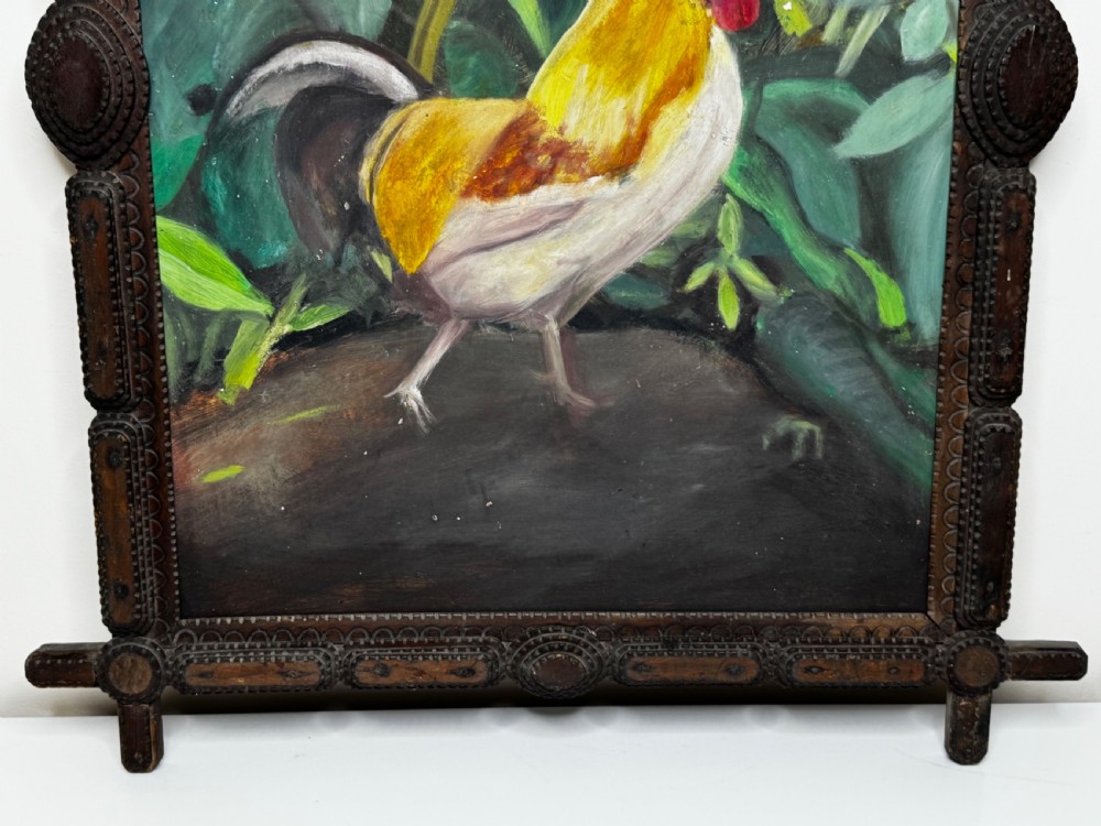 An oil painting depicting a yellow and red cockerel amidst dense green leaves, set within a carved dark wood frame with extended corner joints. View II