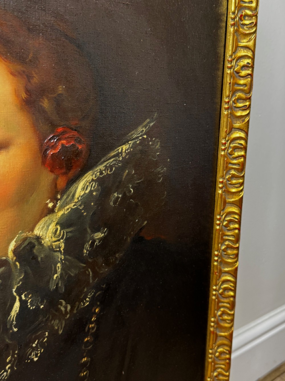 An oil painting depicting a lady in a black gown with a lace ruff collar and gold jewellery, set within an ornate carved giltwood frame. View XXI