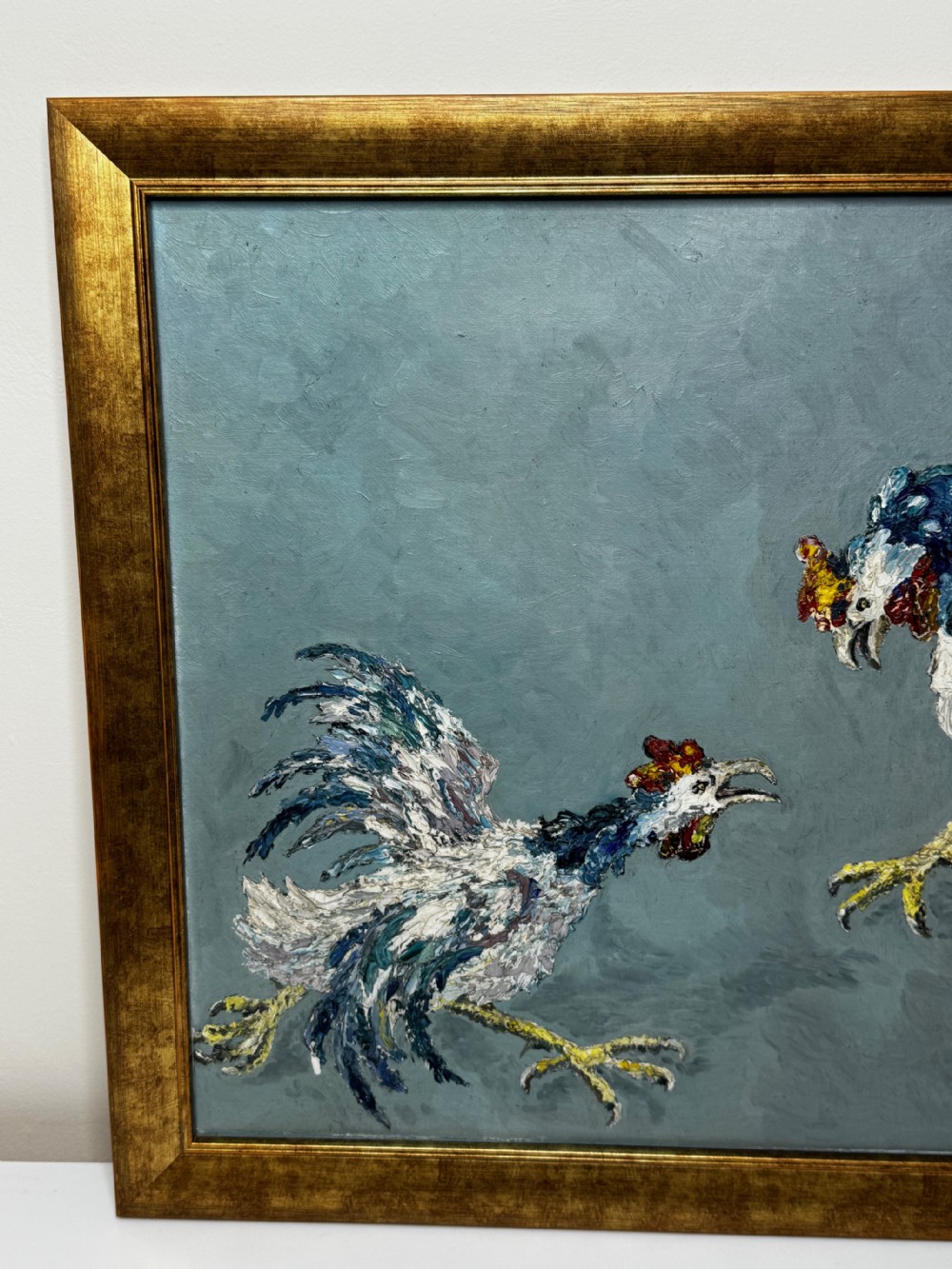 An expressionist impasto oil painting depicting two cockerels in motion against a blue-grey background within a gilt frame. View VI