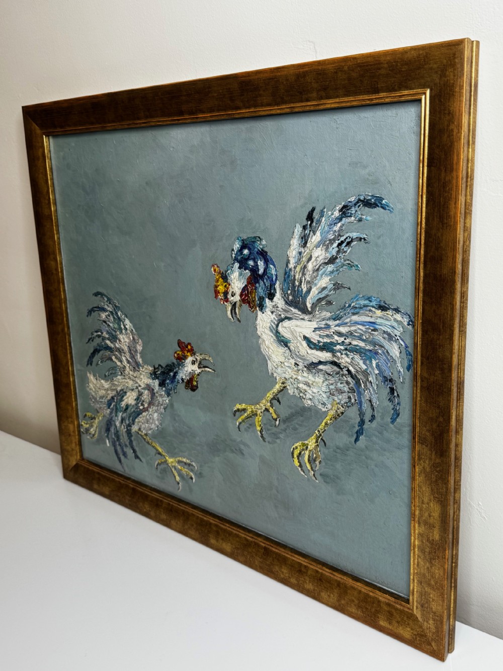 An expressionist impasto oil painting depicting two cockerels in motion against a blue-grey background within a gilt frame. View XIV