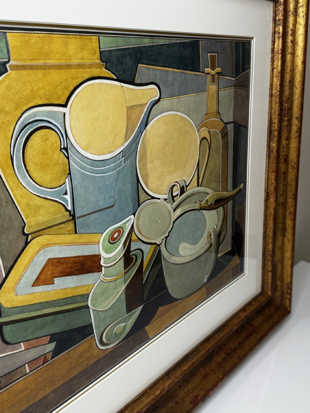 A framed Cubist watercolour still life featuring geometric kitchenware in shades of ochre, grey, and green within a distressed gilt frame. View XI