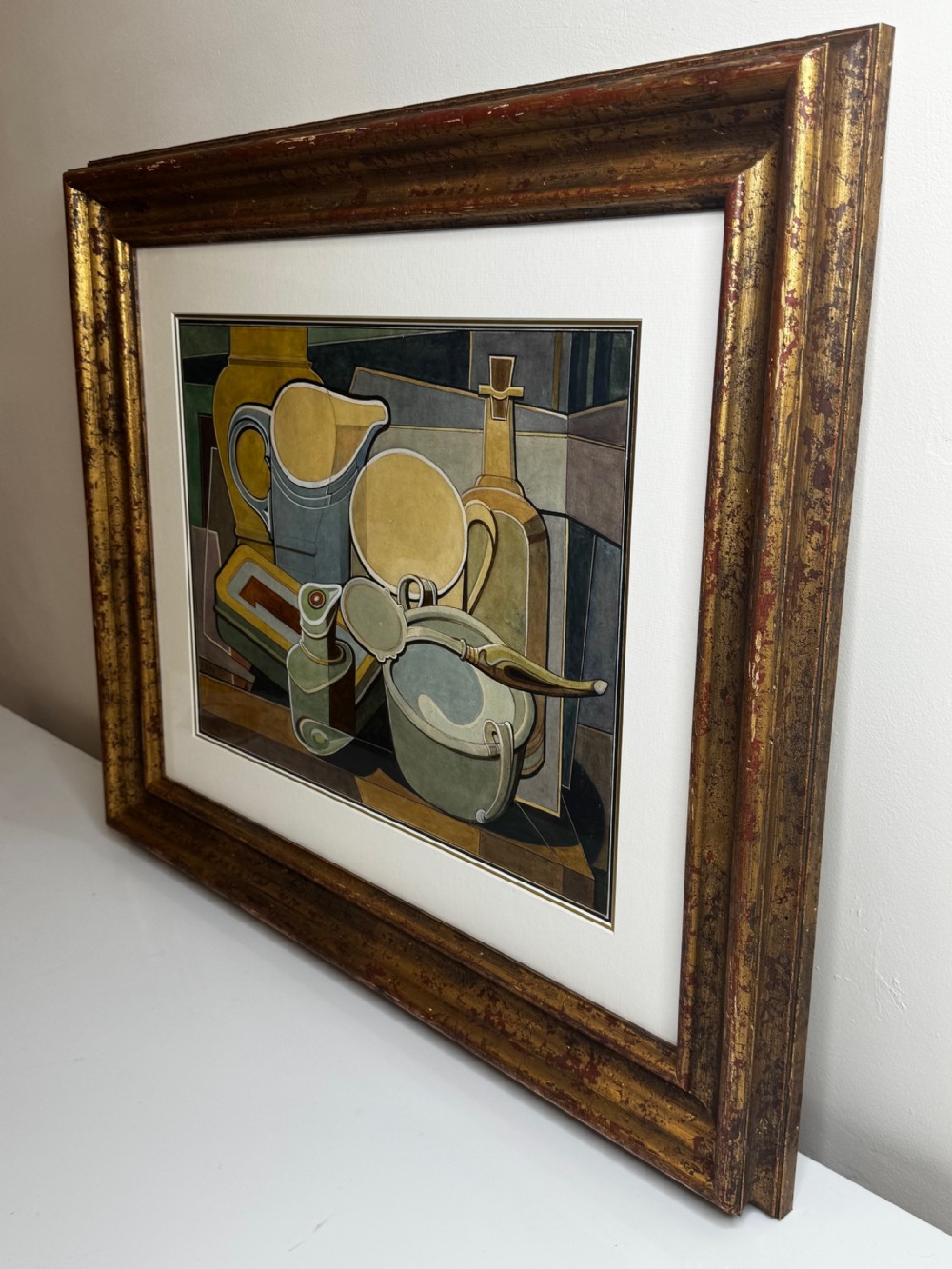 A framed Cubist watercolour still life featuring geometric kitchenware in shades of ochre, grey, and green within a distressed gilt frame. View XIV