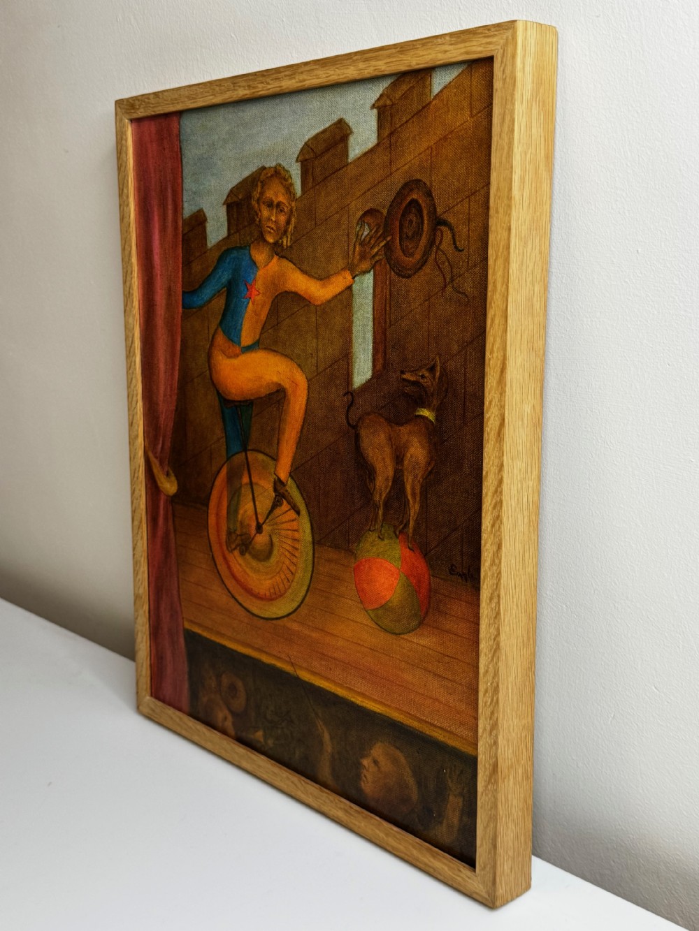 A framed Surrealist oil painting depicting a costume-clad performer on a unicycle next to a dog balancing on a sphere against a stone wall. View X