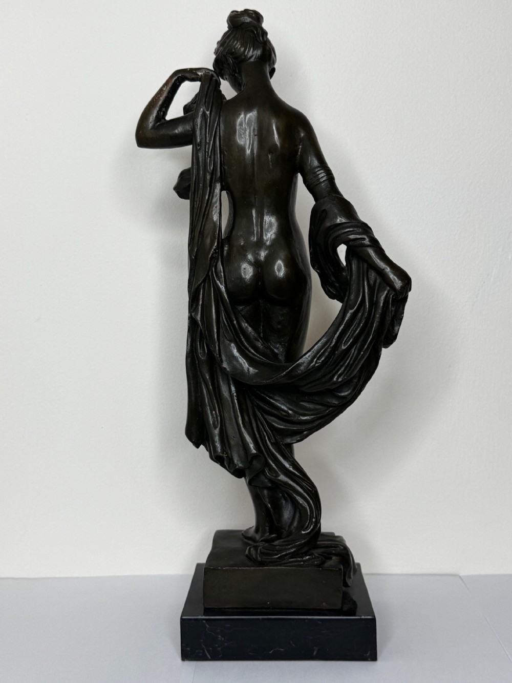 A French bronze sculpture depicting a standing allegorical female nude figure draped in fabric on a dark marble base. View XXI