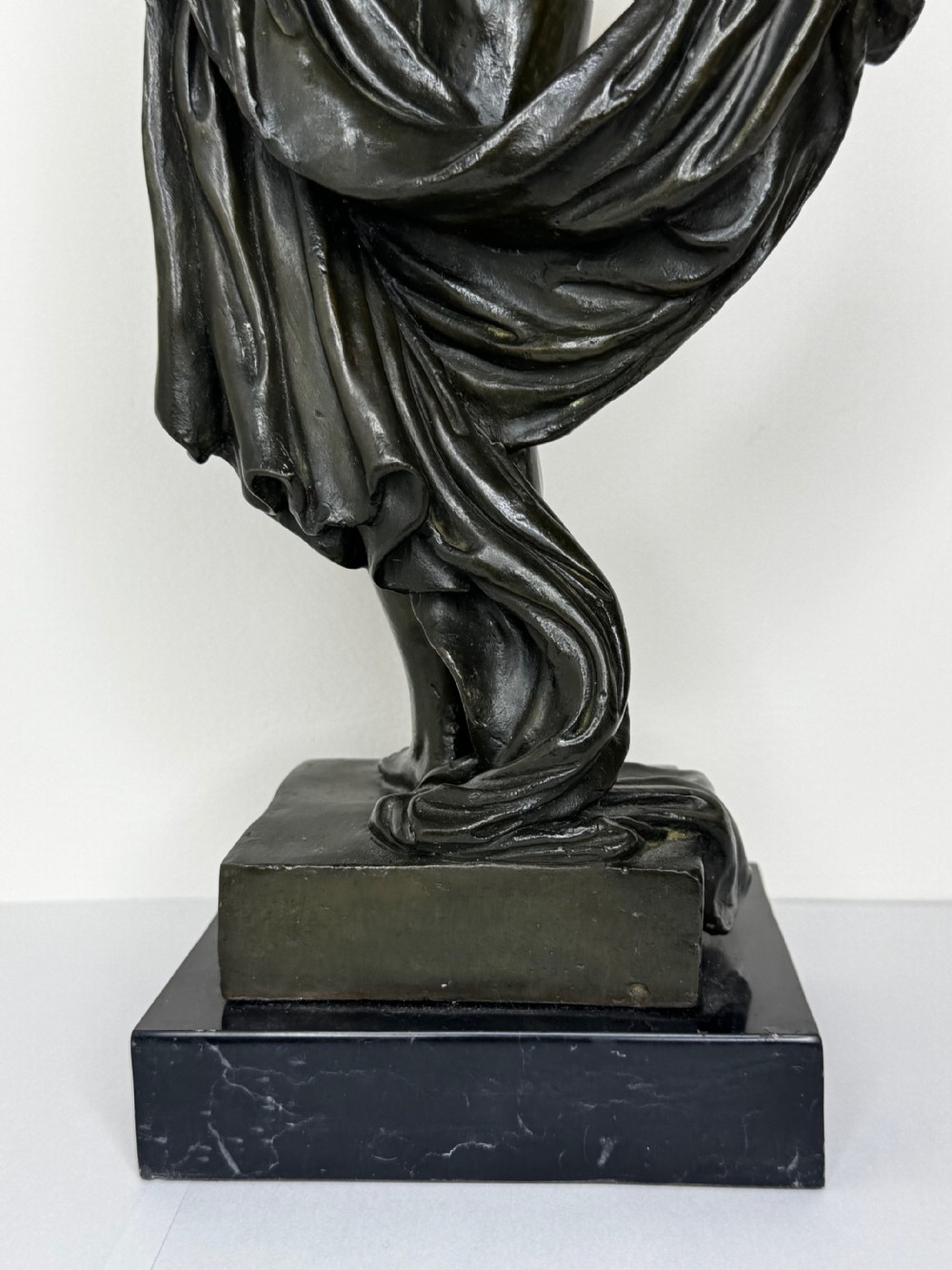 A French bronze sculpture depicting a standing allegorical female nude figure draped in fabric on a dark marble base. View XXII