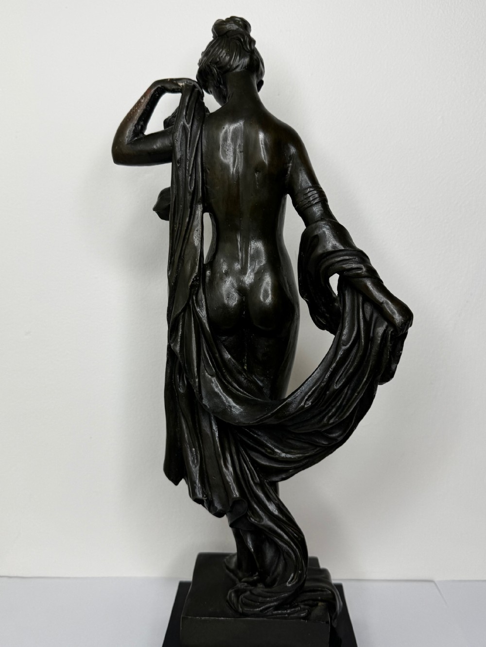 A French bronze sculpture depicting a standing allegorical female nude figure draped in fabric on a dark marble base. View XXV