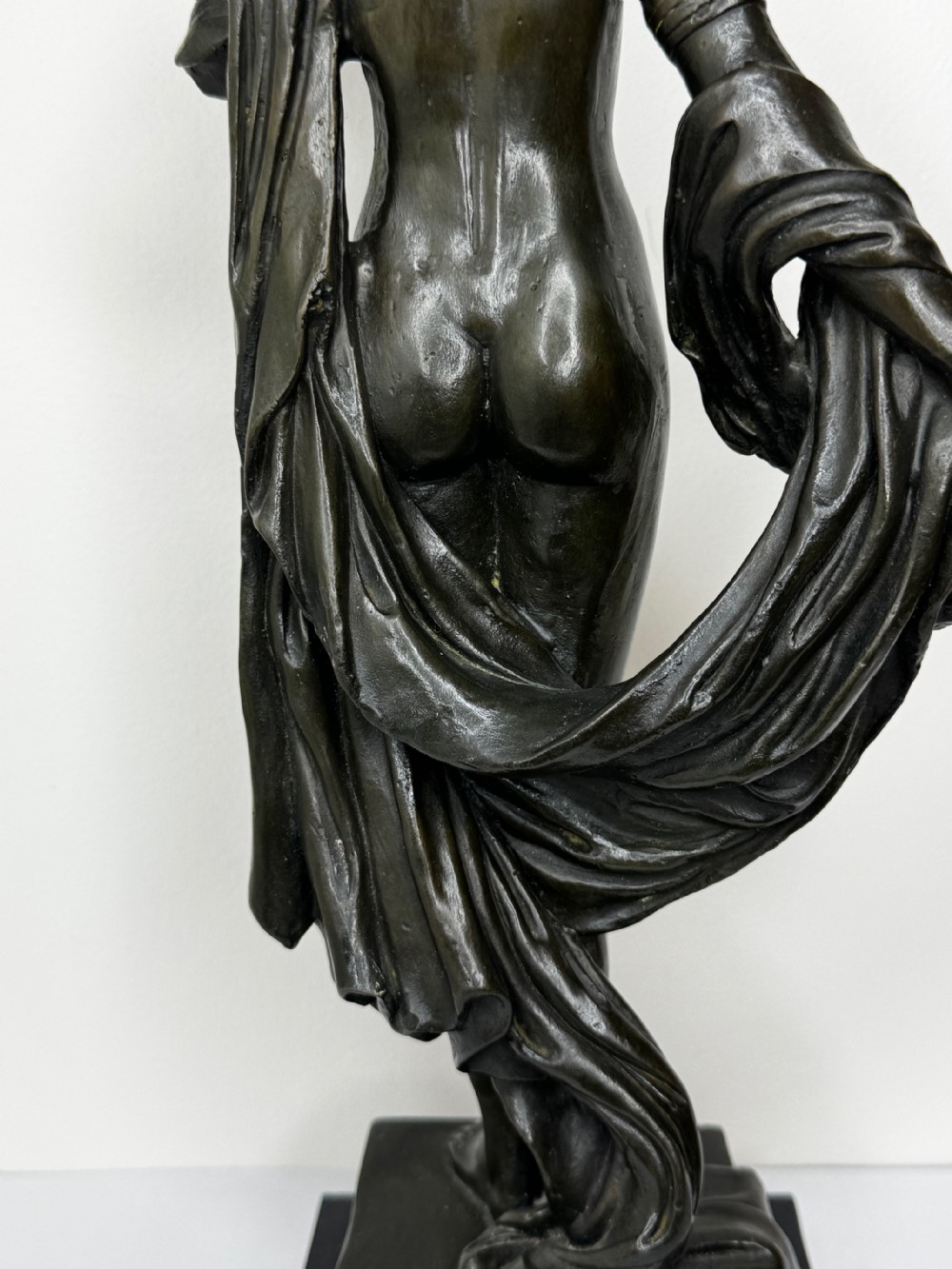 A French bronze sculpture depicting a standing allegorical female nude figure draped in fabric on a dark marble base. View XXVI