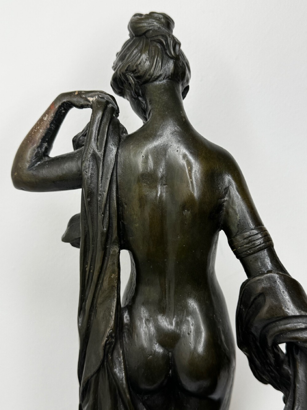 A French bronze sculpture depicting a standing allegorical female nude figure draped in fabric on a dark marble base. View XXIX