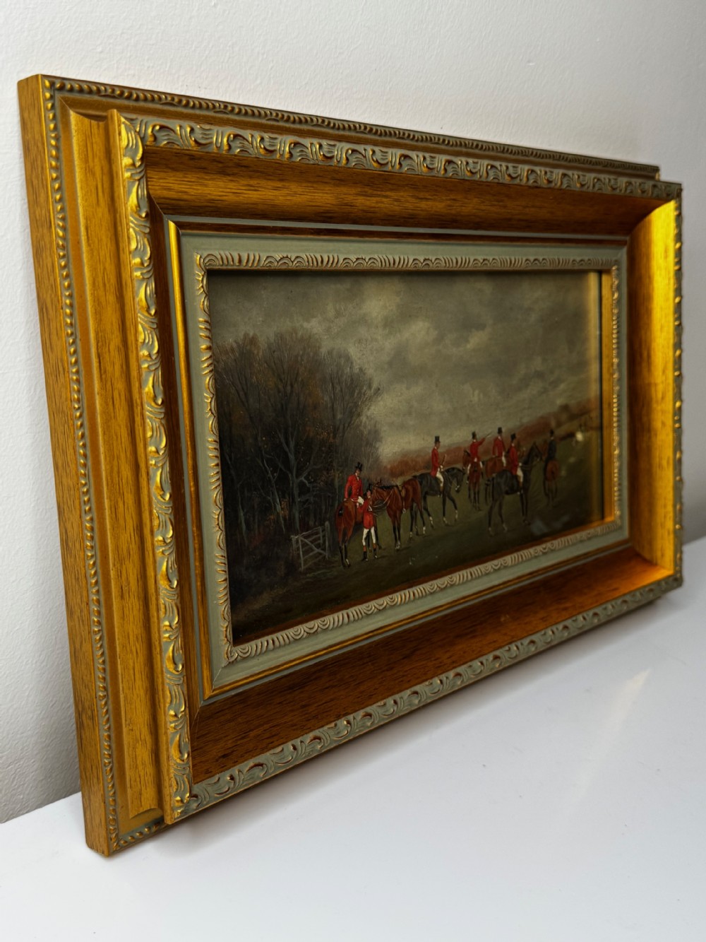 A 19th-century oil painting depicting equestrian fox hunters gathered in an open field, set within a heavily moulded gold gilt frame. View VIII