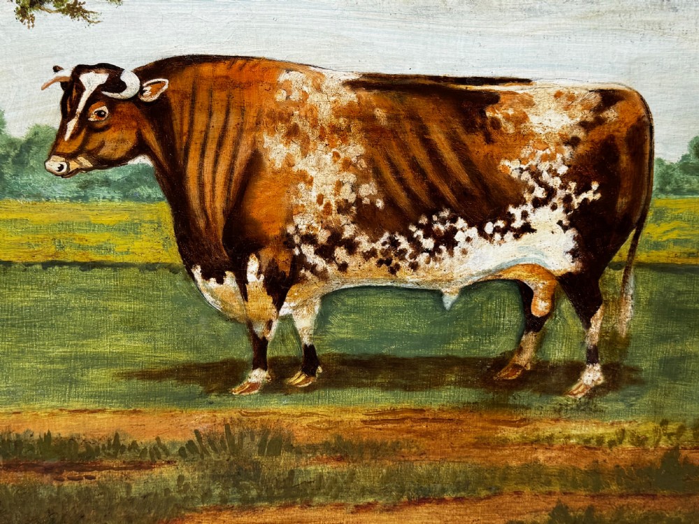 A 19th-century oil painting depicting a brown and white shorthorn bull standing in side profile in a green field, encased in a gilded frame. View X