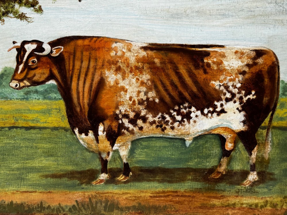 A 19th-century oil painting depicting a brown and white shorthorn bull standing in side profile in a green field, encased in a gilded frame. View XI