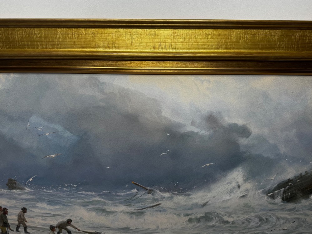 A 19th-century oil painting depicting figures on a shore watching a shipwreck in turbulent seas, set within a molded gilt frame. View X