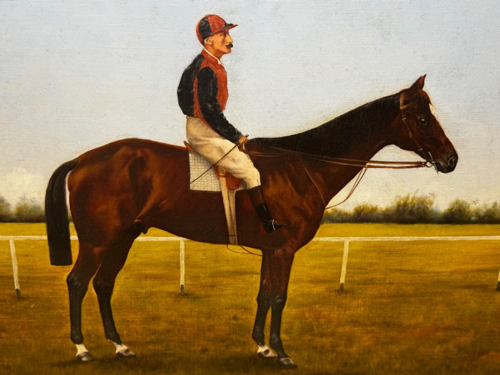 A framed Victorian oil painting depicting a bay racehorse and mounted jockey against a blue sky and green racecourse backdrop. View XVI