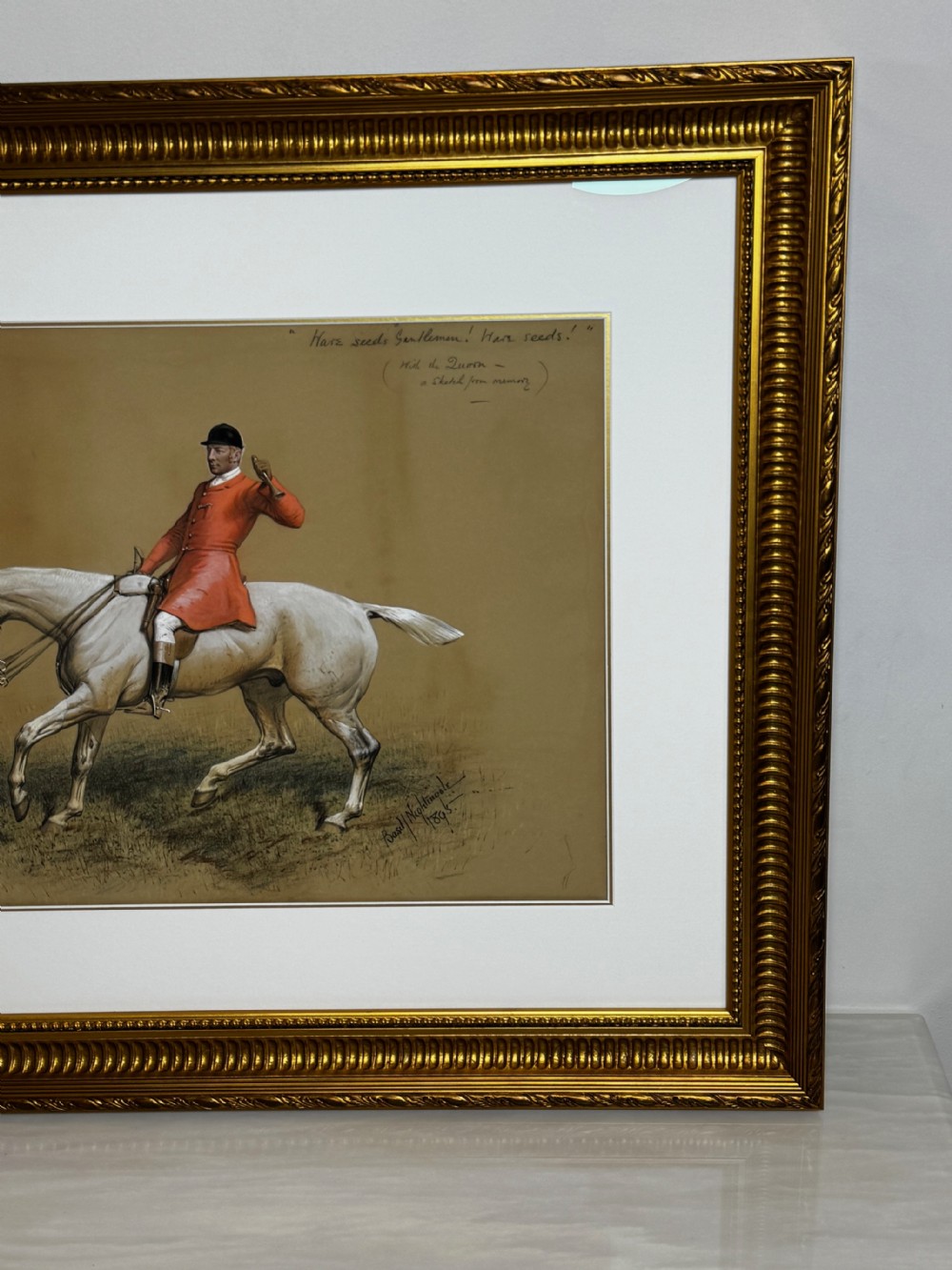 A framed Victorian equestrian painting depicting a huntsman in a red coat riding a grey horse, set within a gilt moulded frame. View IV
