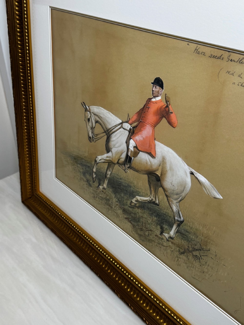 A framed Victorian equestrian painting depicting a huntsman in a red coat riding a grey horse, set within a gilt moulded frame. View VIII