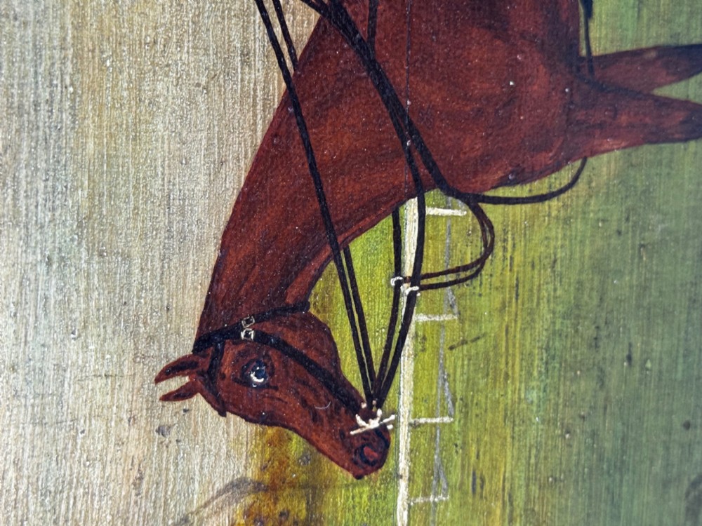 An oil painting depicting a brown thoroughbred racehorse with a jockey in red and blue silks, set within a wide gilded frame. View X