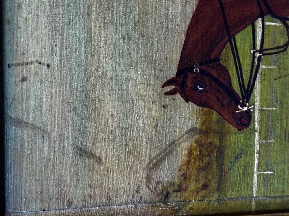 An oil painting depicting a brown thoroughbred racehorse with a jockey in red and blue silks, set within a wide gilded frame. View XV
