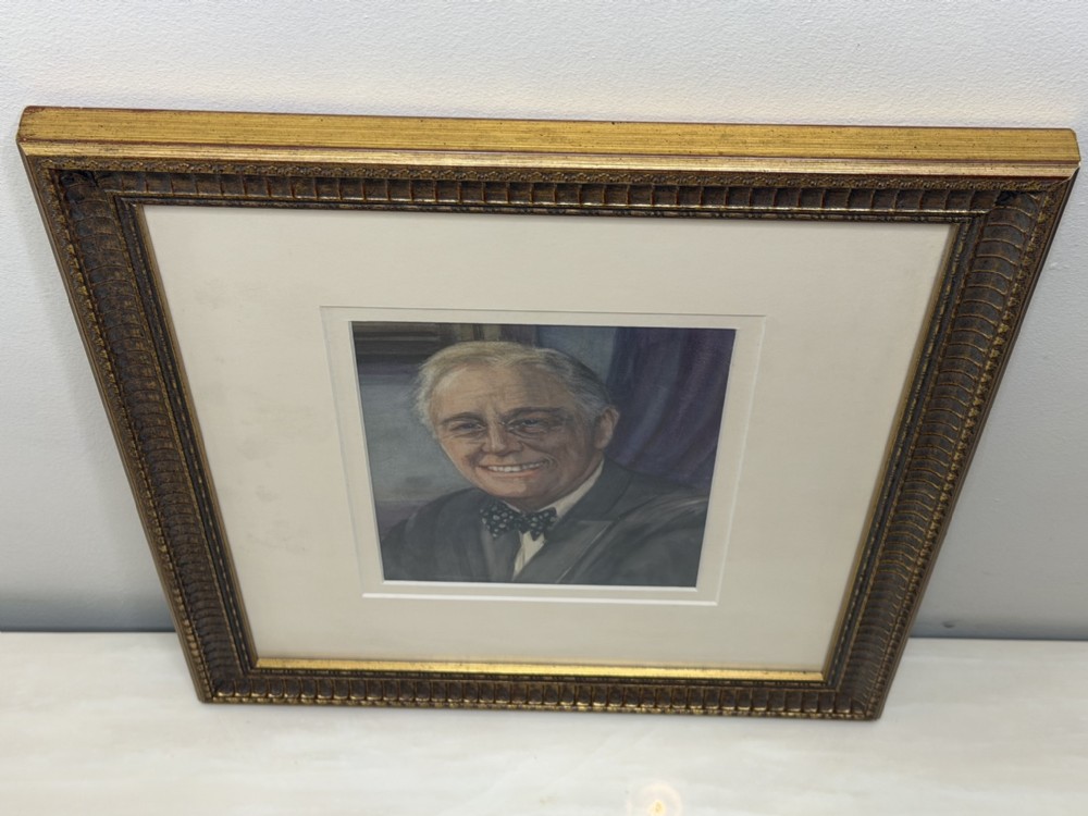 A framed portrait painting depicting Franklin D. Roosevelt set within a broad cream mount and a textured gold-tone wooden frame. View II