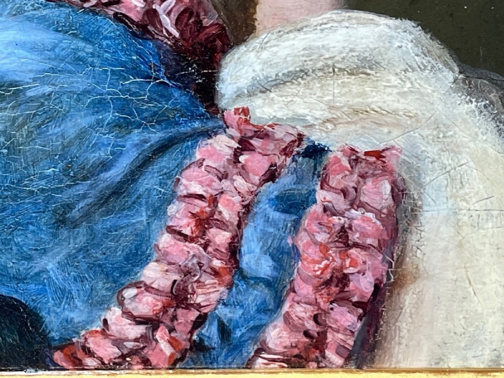 A Victorian oil portrait depicting a young woman with a flower in her hair wearing a blue dress, set within an ornate gilt frame. View X