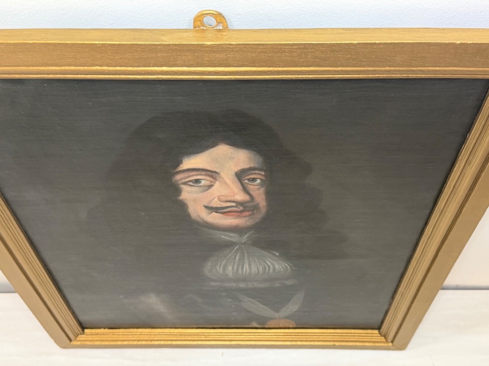 A 19th-century framed oil portrait depicting King Charles II wearing armour, a white lace cravat, and the Order of the Garter medallion against a dark background. View IV
