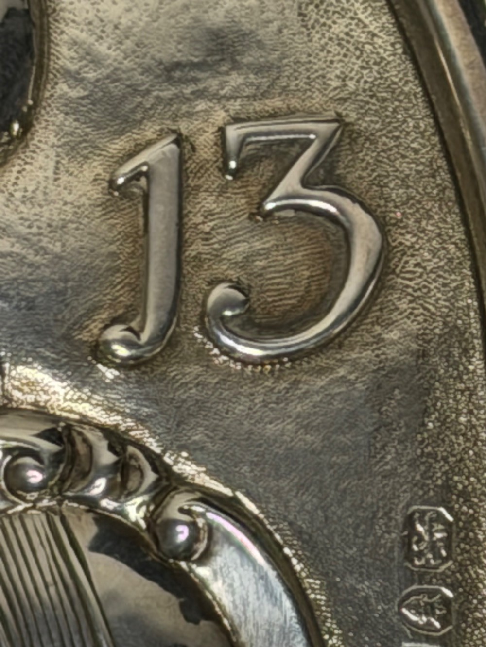 An oval George III sterling silver plaque featuring an embossed relief of Britannia holding a spear beside a shield and harp with embossed text reading London Assurance. View VII