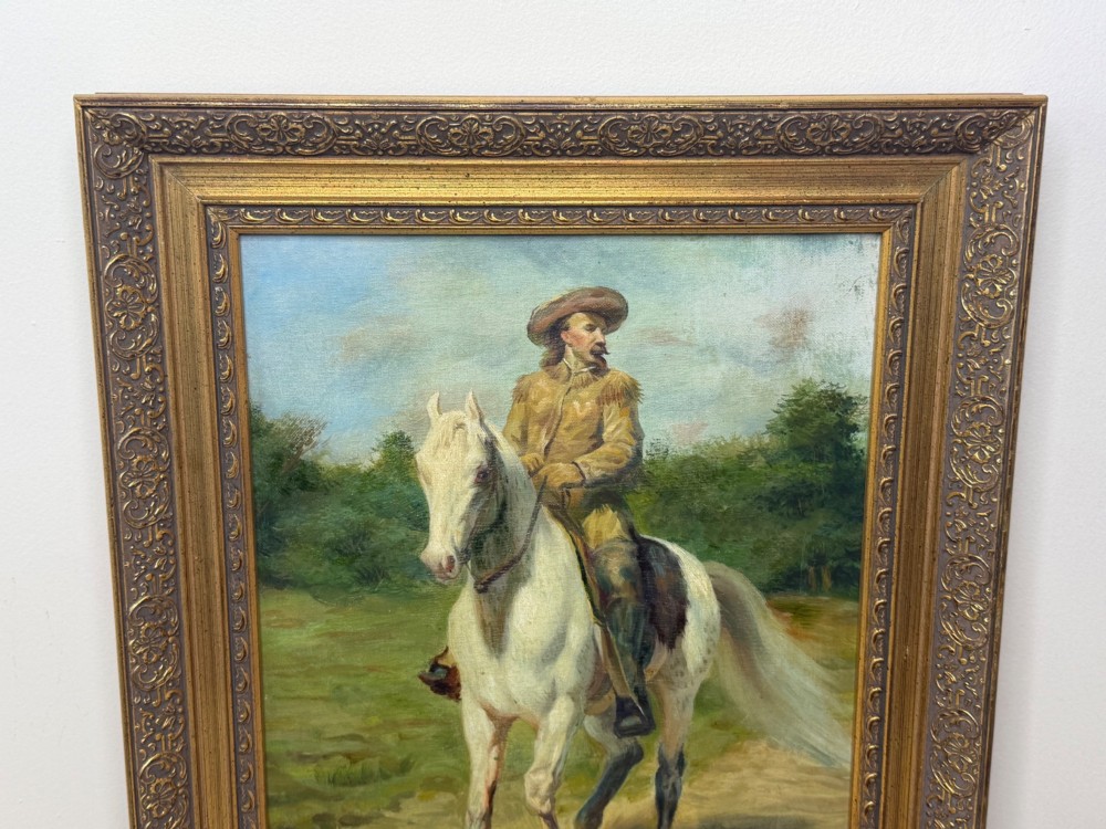 An oil painting depicting a man in a hat and buckskin jacket riding a grey horse along a rural path, set within an ornate gilded wooden frame. View V