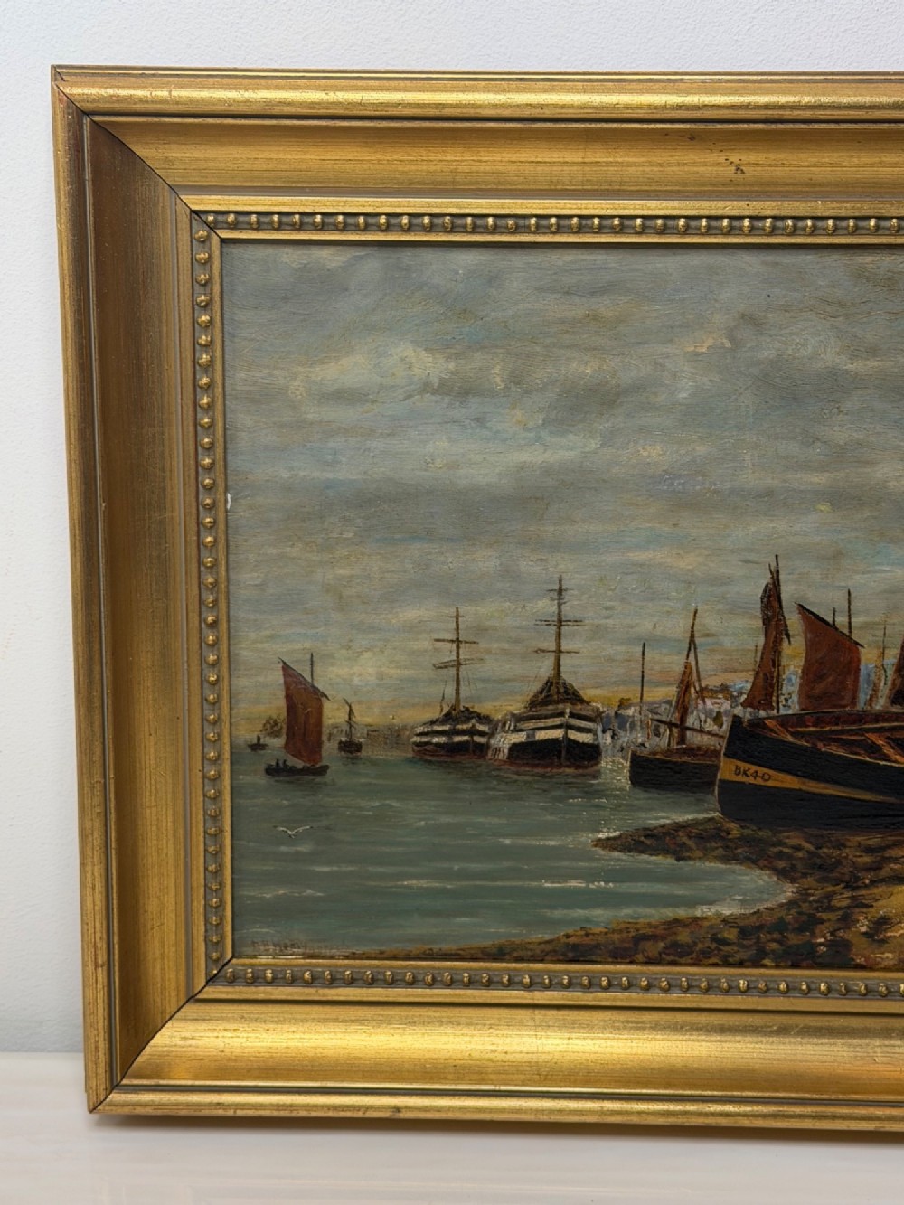 A 19th-century framed oil painting depicting sailing boats in North Shields harbour under an overcast sky. View V