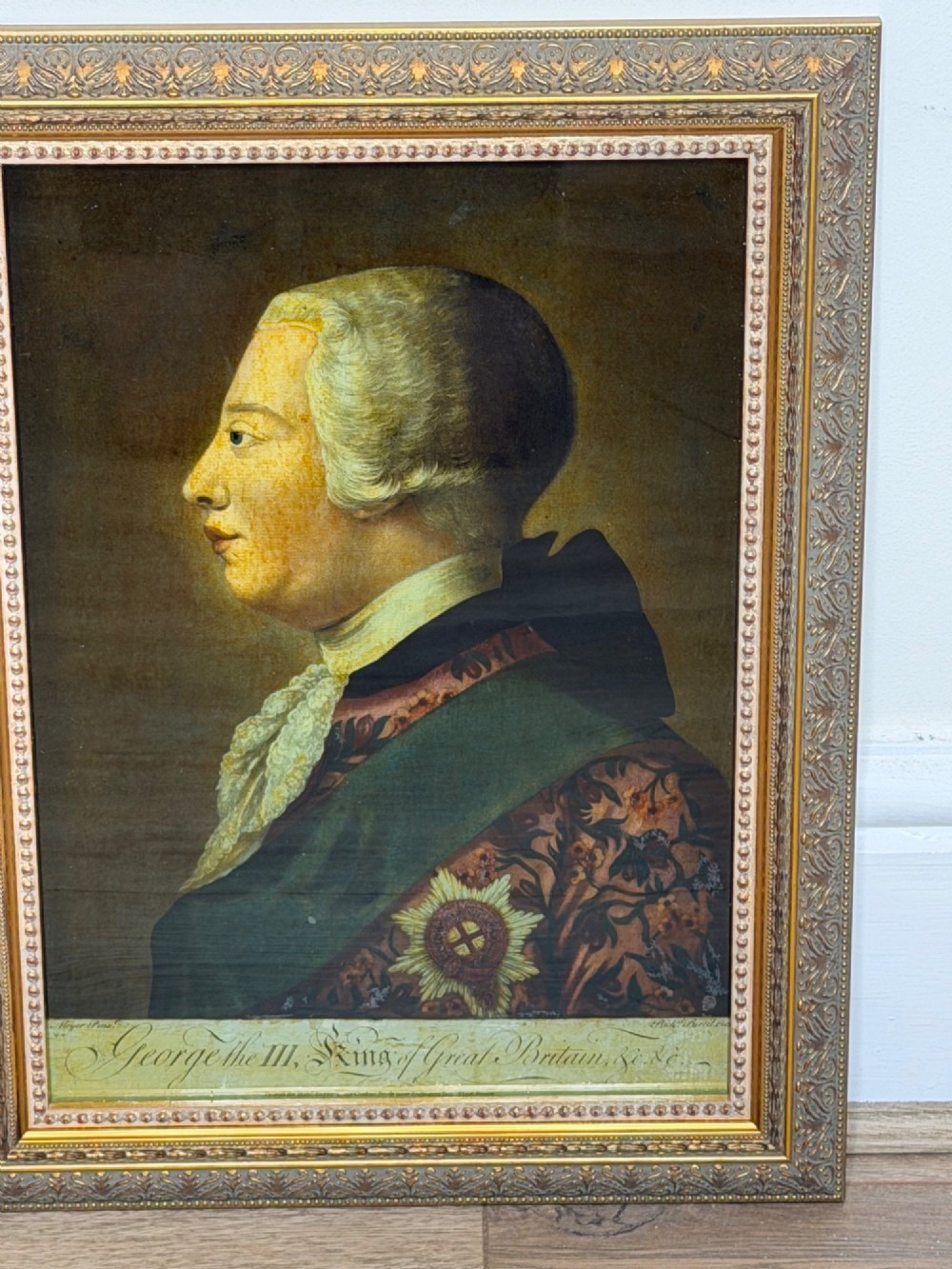 An 18th-century reverse glass mezzotint profile portrait of King George III housed within a decorative gilt frame. View II