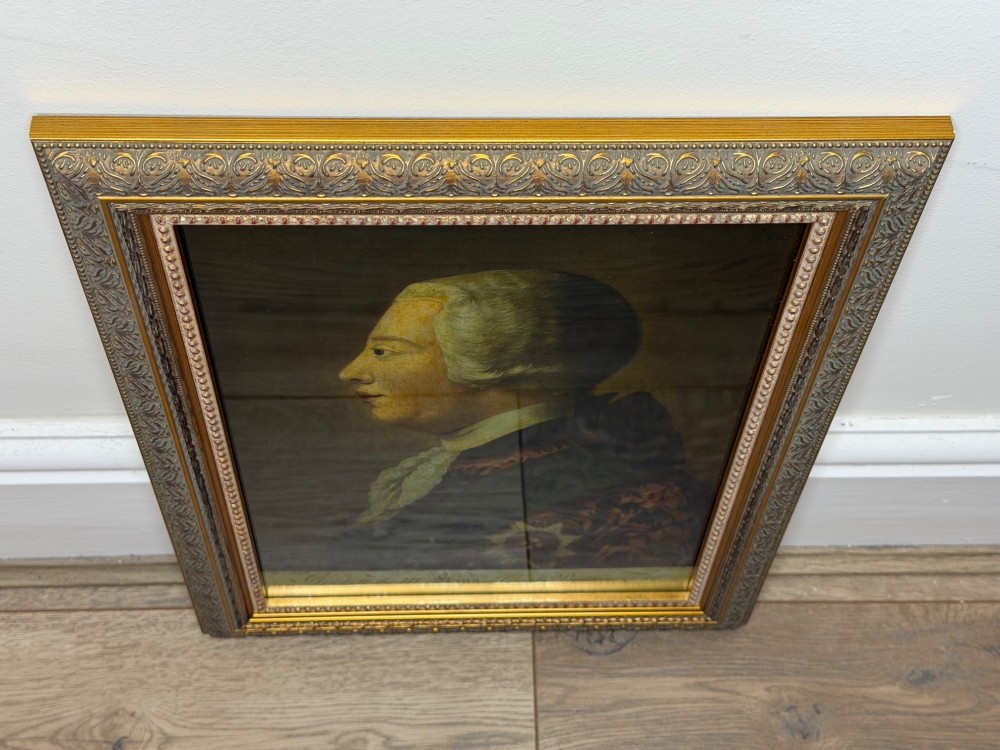 An 18th-century reverse glass mezzotint profile portrait of King George III housed within a decorative gilt frame. View VI
