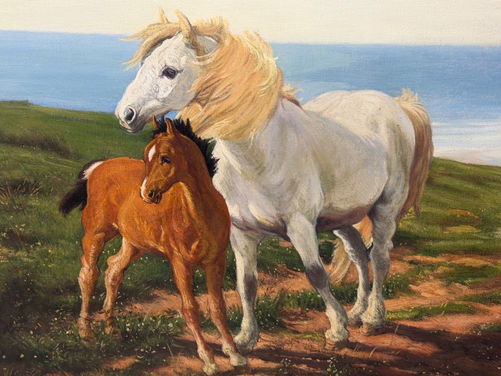 A framed oil painting featuring a grey mare standing beside a young chestnut foal on a grassy coastal headland overlooking the sea. View VII