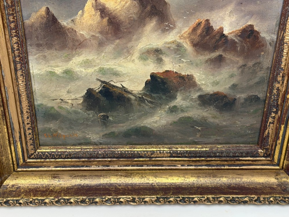 A vertical oil painting framed in carved gold leaf depicting La Corbiere lighthouse atop jagged rocks amidst a stormy grey sea with a shipwreck in the foreground. View II