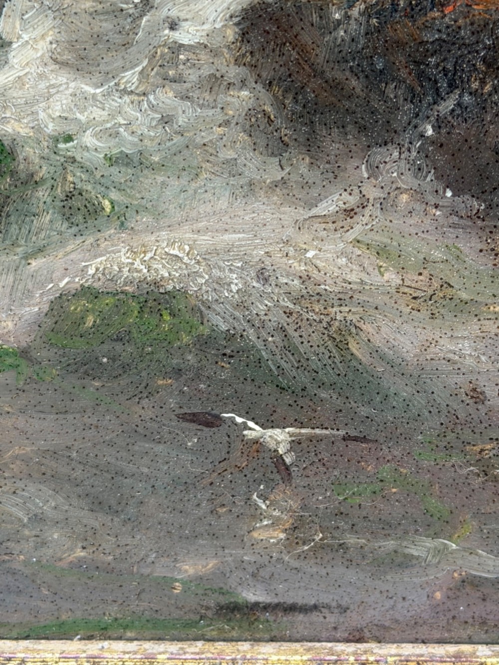 A vertical oil painting framed in carved gold leaf depicting La Corbiere lighthouse atop jagged rocks amidst a stormy grey sea with a shipwreck in the foreground. View IX