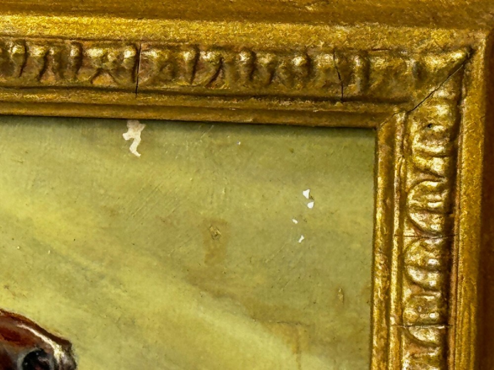 An antique oil painting depicting a chestnut Arabian horse standing in profile against a green draped backdrop within a moulded gold giltwood frame. View X